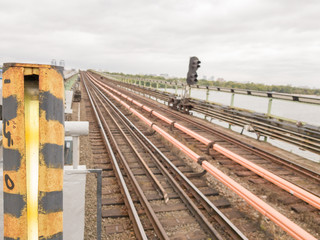 Railroad tracks subway on the bridge in the open air. Railway, rails in city. Travel concept, train trip, rest. The urban metro traffic.
