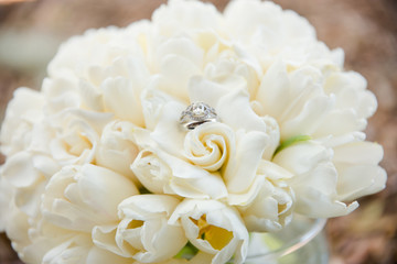 White Wedding Bouquet of White Flowers with Wedding Ring on It