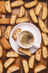 Cup of Tasty Espresso Black Coffee and Italian Almond Biscuit Biscotti on Wooden Background Italian Dessert for Coffee or Wine Top View Vertical
