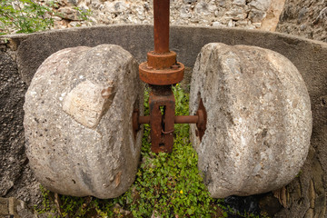 old olive press in abandoned village of Palia Plagia, Greece