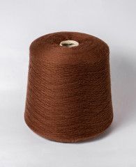 bobbin of yarn on a white background. Side view.Textile reel on isolated white background.