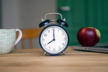 Alarm clock on the table. Time management and morning concept