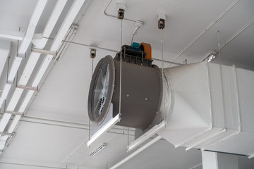 Close-up large fan of industrial ventilation system in white building.