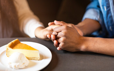 Young lovebirds holding hands while lunch time