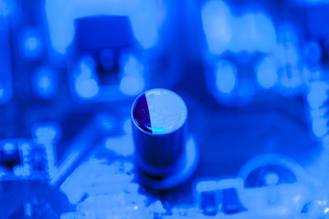 Blue themed circuit board with capacitor