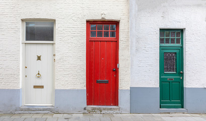 Old wooden door and window on the brick wall background