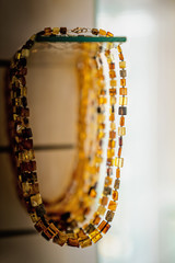 Amber neklaces on a glass shelf