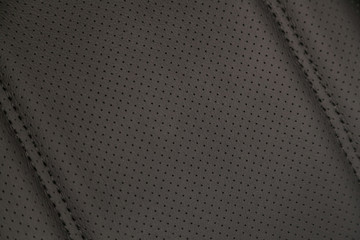 Part of leather car headrest seat details. Сlose-up gray  perforated leather car seat. Skin texture