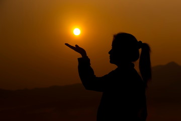 Silhouette of young beautiful girl on sunrise, silhouette style