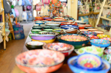 Fototapeta na wymiar selling of multicolored ceramic dishes in the store