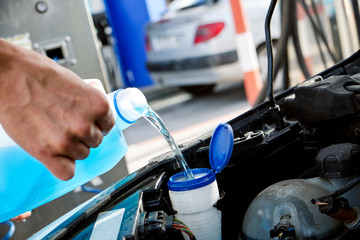 filling the tank of windshield washer fluid