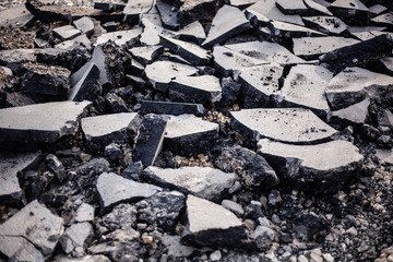 Asphalt repair. Asphalt removed from the road. Preparation for the construction of a new road. Improvement of the city and streets. Concrete is removed and broken.