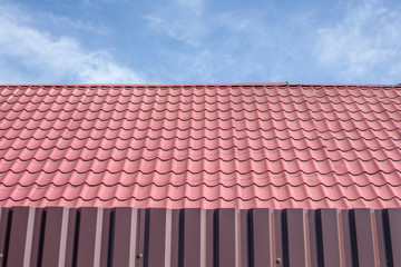 Roofing roof. Roof covering of a country house. The tile is laid in even rows.