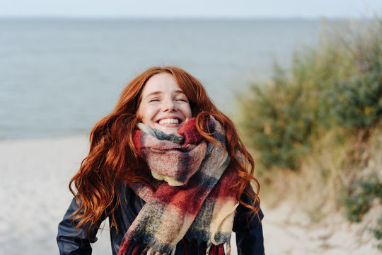Joyful happy young redhead woman