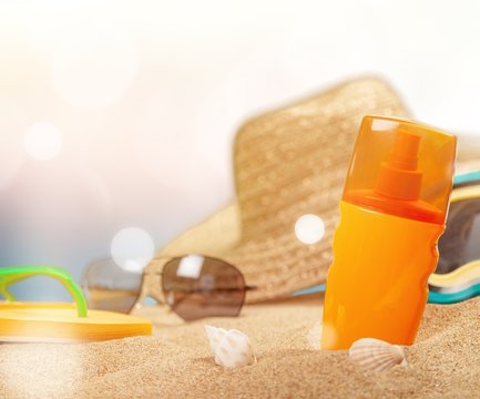 Bottle Of Sunscreen Lotion On The Sandy Beach