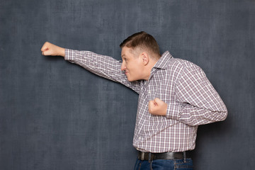 Funny awkward man is posing like brave flying superman