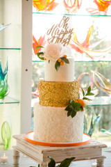 White and Gold Tiered Wedding Cake with Oh Happy Day Sign and Flowers with Citrus Decor