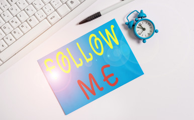 Writing note showing Follow Me. Business concept for Inviting a demonstrating or group to obey your prefered leadership Flat lay above empty note paper on the pc keyboard pencils and clock