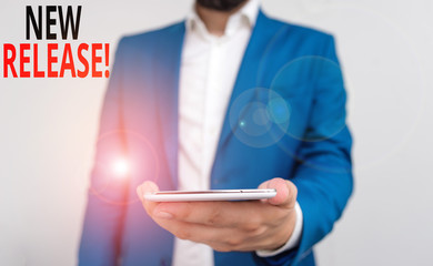 Word writing text New Release. Business photo showcasing announcing something newsworthy recent product Business concept with man holding mobile phone with touch screen