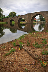 Fototapeta premium Old stone bridge over river in Spain