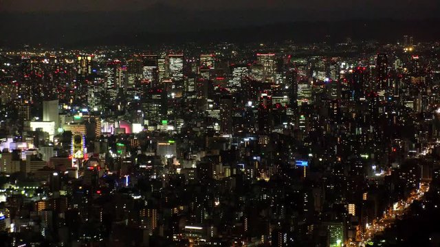 OSAKA, JAPAN - CIRCA SEPTEMBER 2019 : Aerial high angle sunrise view of CITYSCAPE of OSAKA. Time lapse shot, night to morning. Osaka is the second largest metropolitan area in Japan.