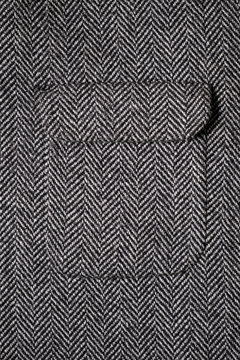 The texture of the fabric for the coat. Closeup of wool herringbone fabric. weed, Wool Background Texture.