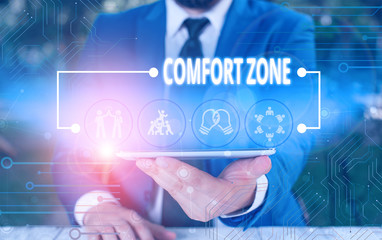 Writing note showing Comfort Zone. Business concept for place or situation where one feels safe and without stress Male wear formal work suit presenting presentation smart device
