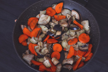 Hot spicy stewed eggplant, bell peppers and carrots in a pan.