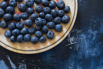 Fresh blueberries in wooden dish