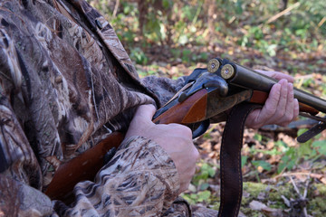 Hunter Loads a double-barreled shotgun with ammunition on the hunt.