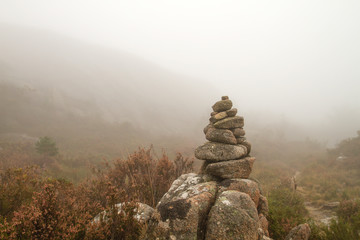 Cairn or stones pile marking a mountain trail