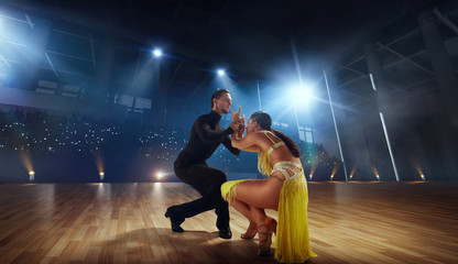 Couple dancers  perform latin dance on large professional stage. Ballroom dancing.