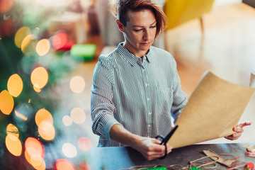Woman preparing to wrap a Christmas presents