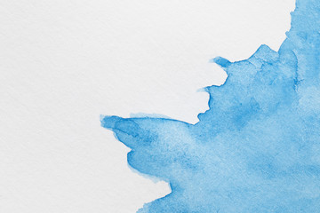 Abstract coloured ink waves on white surface
