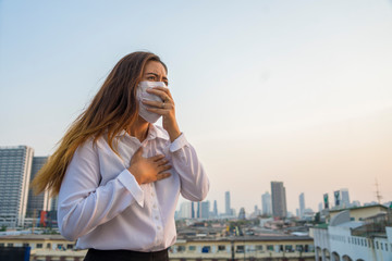 Asian woman officer wearing masks protect toxic dust in the air are polluting the capital of Bangkok.Thailand Bangkok Having to air PM25 (fine particulate matter) pollution crisis.