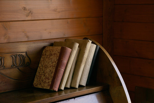 Vintage books on the shelf in wagon of train from 1920th