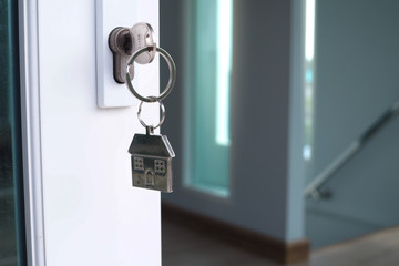 The house key for unlocking a new house is plugged into the door.