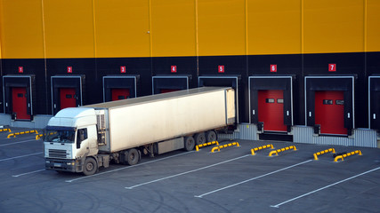 Unloading trucks at a modern warehouse complex.