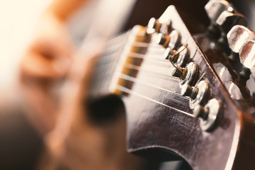 Close up of man's hands playing acoustic guitar