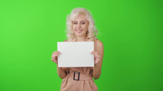 Woman showing blank white big A4 paper. Leaflet presentation. Pamphlet hold hands. Girl show clear offset paper.