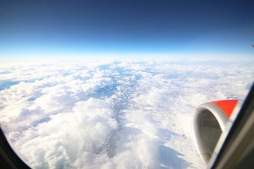 Naklejka na ściany i meble View of sky and clouds from airplane window. Norway