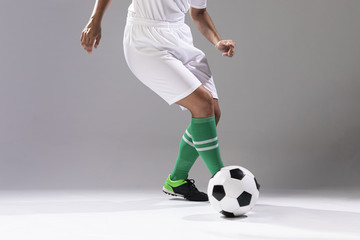 Woman in sportswear playing with ball