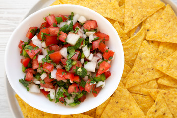 Pico de Gallo with gluten free chips, top view. Flat lay, overhead, from above. Close-up.