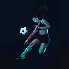 Fit young girl kicking soccer ball