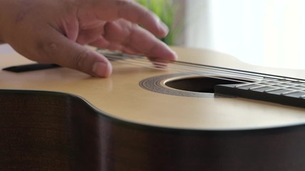 Close-up hands of man playing acoustic classic guitar, Music instrumental for jazz and easy listening music style select focus shallow depth of field