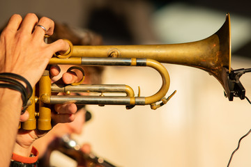 Trumpet. Close-up. Shows the musician's play on