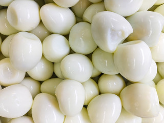 a large pile of boiled peeled fresh eggs
