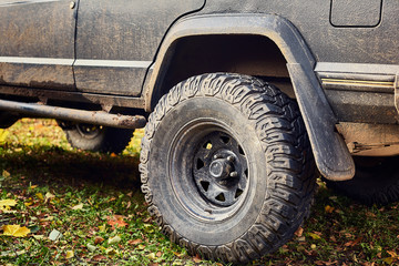 Fototapeta na wymiar dirty back wheel of the jeep close-up