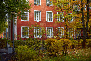 old red house in the Park among the trees