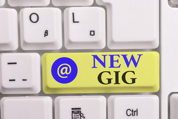 Writing note showing New Gig. Business concept for getting job Attending live Concert Gigabyte Freelancer offer White pc keyboard with note paper above the white background